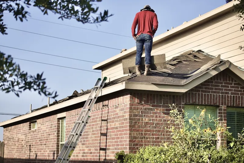 Professional roofer working on a residential roof in Childs Acres